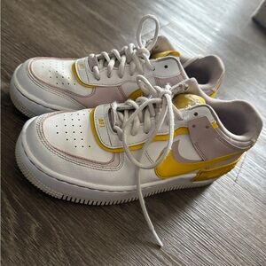 Nike woman’s Two-Tone White, Yellow & Pink Low-Top Sneakers